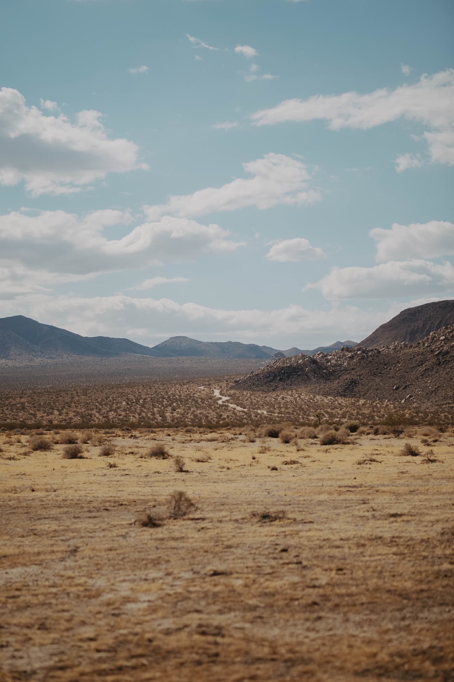 A dry desert valley under a blue sky