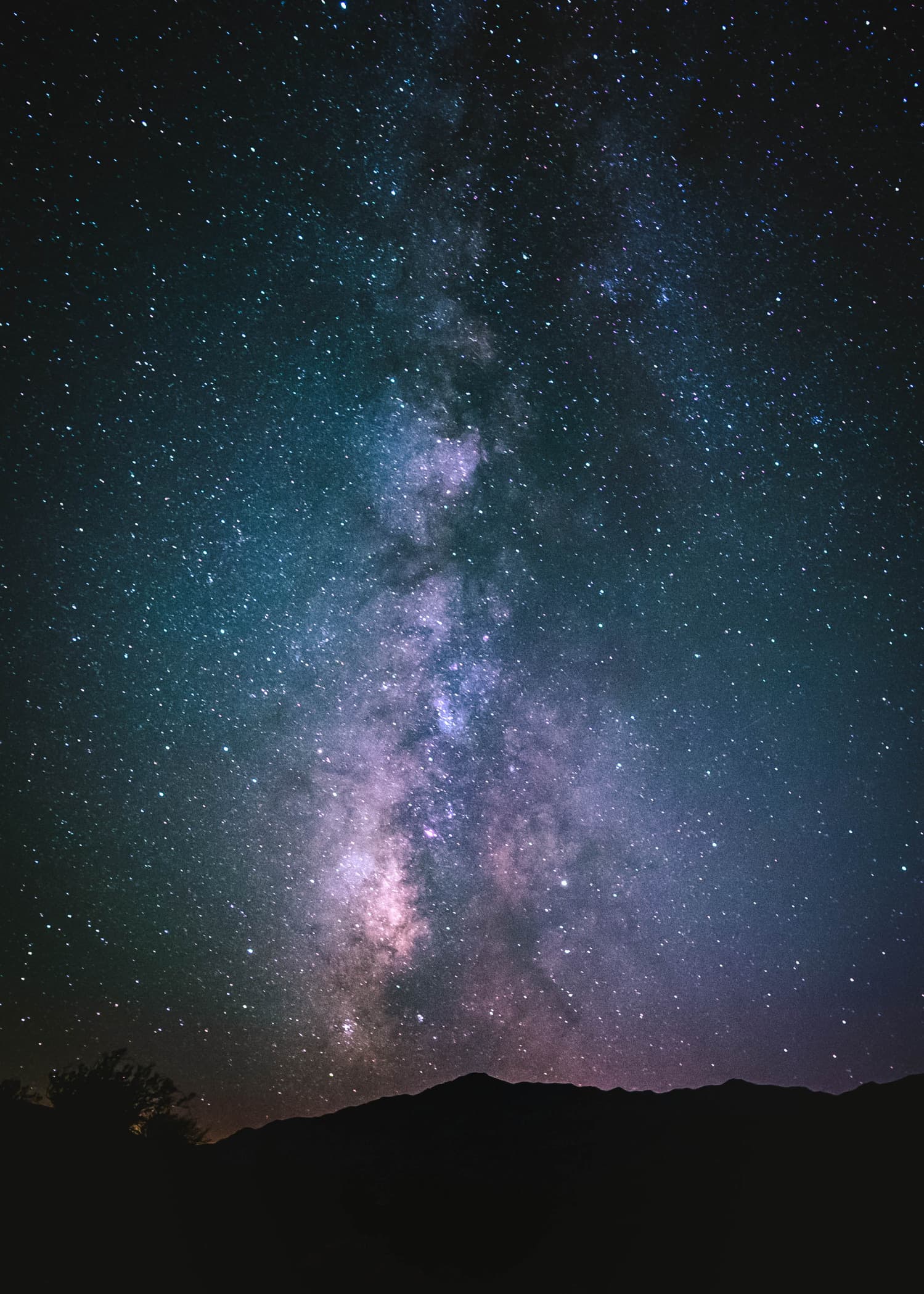 The Milky Way over dark desert ridges