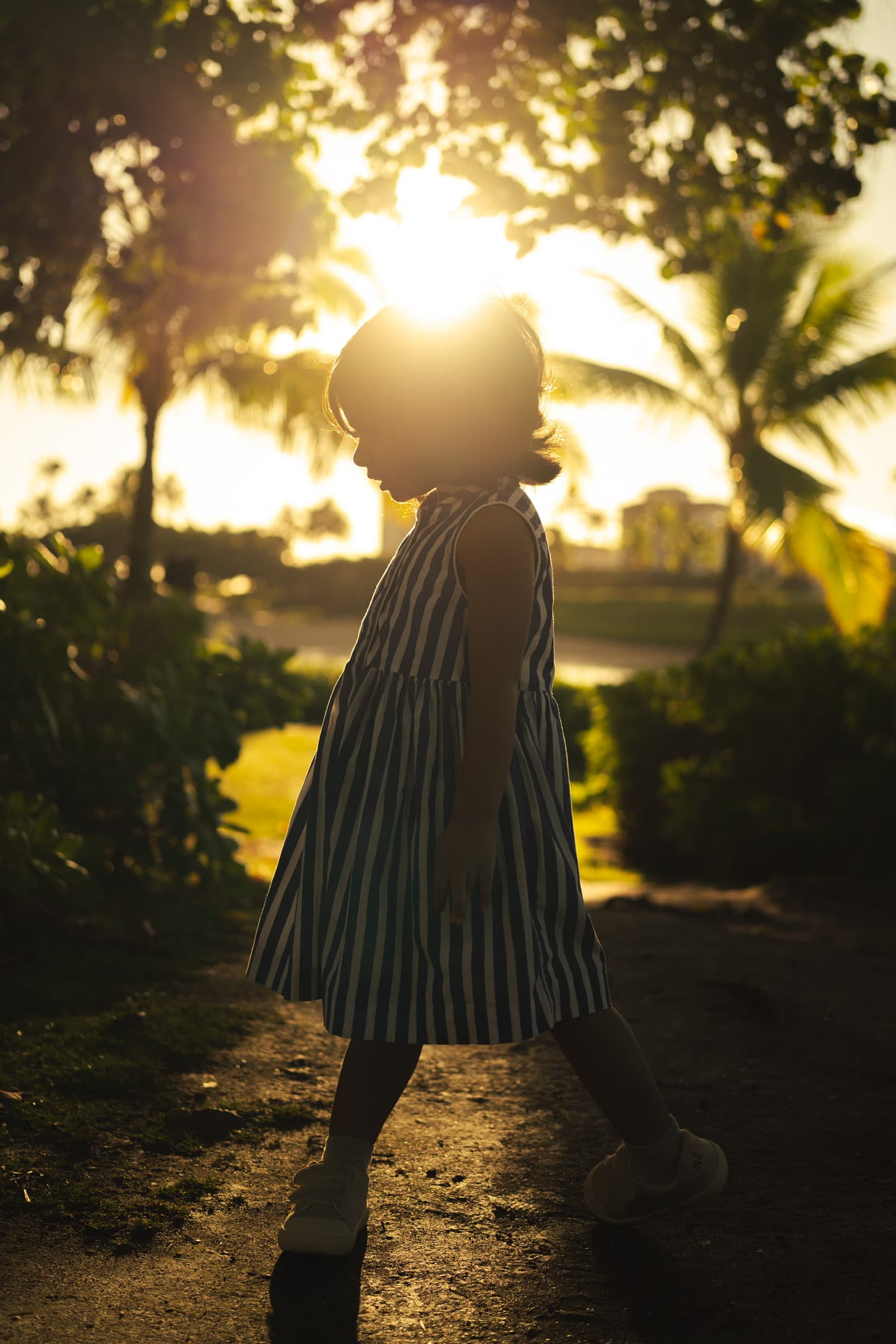 A child walking through golden light in a garden